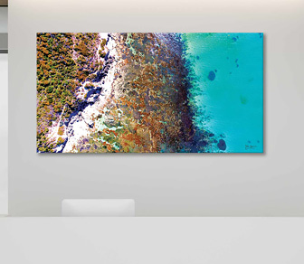 Picturesque birds-eye view aerial photograph of the WA coastline in all it's beauty. The gorgeous crystal clear water in cooling shades of blue showcasing the colourful reef just beneath it's surface meets with the pristine shoreline that is Cape Peron Beach - this photographic print is available in a selection of canvas sizes.